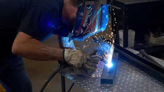  a person with a helmet welding